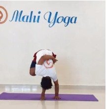 A man performing Ardha Baddha Padmottanasana - Half Bound Lotus Forward Bend during yoga practice.