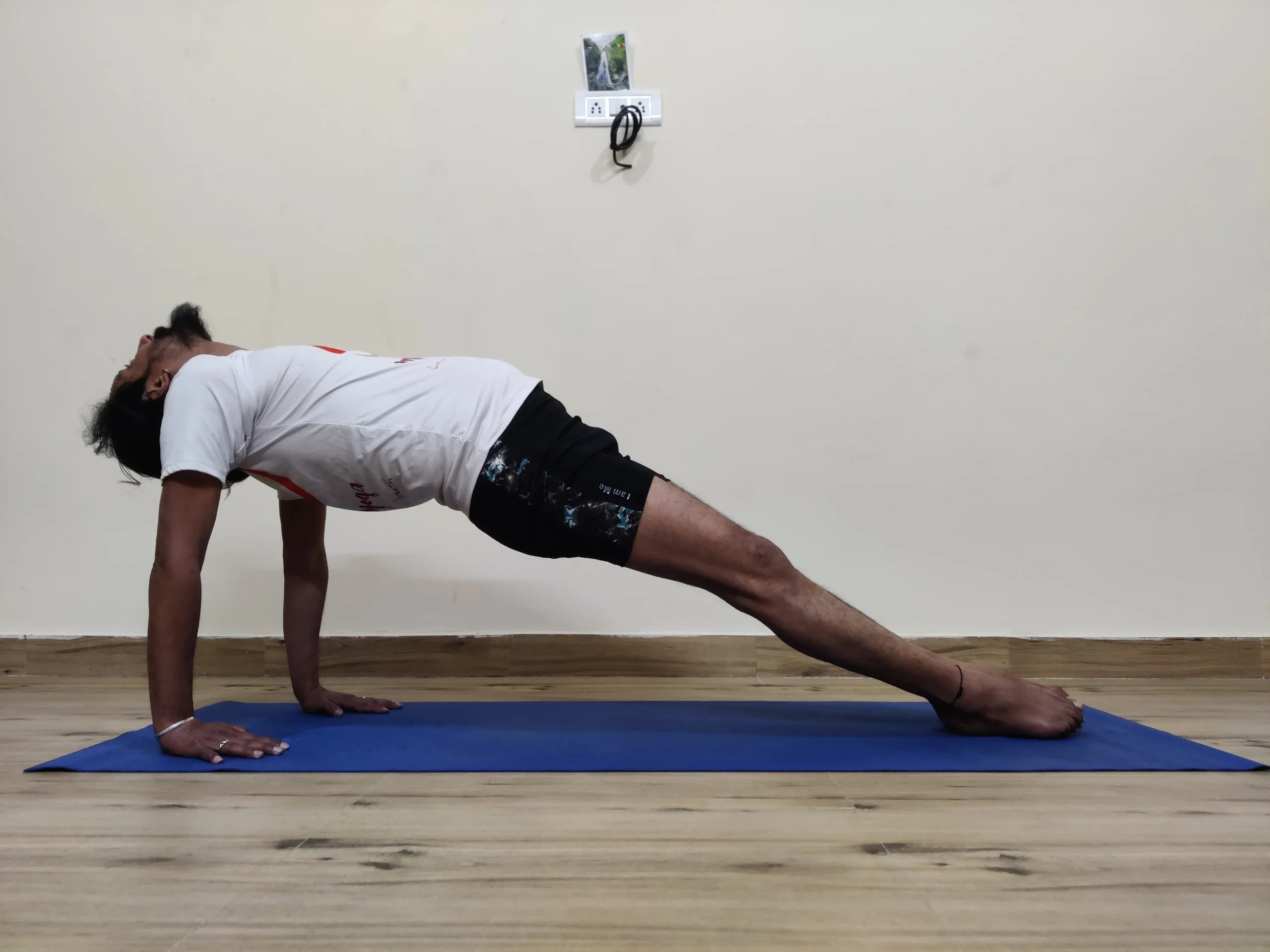 A man performing Purvottanasana, also known as Upward Plank Pose, in yoga.