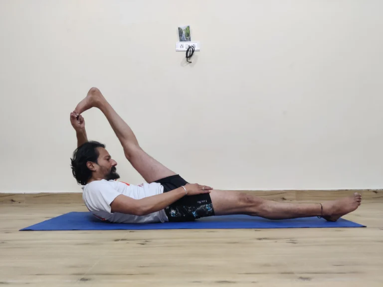 A person practicing Supta Padangusthasana, or Reclining Hand-to-Big-Toe Pose, in yoga.