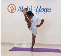 A man performing Utthita Hasta Padangusthasana A - Extended Hand-to-Big-Toe Pose during a yoga session.