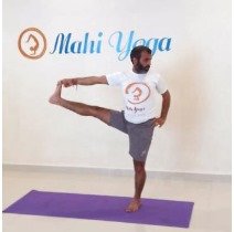 A man performing Utthita Hasta Padangusthasana C - Extended Hand-to-Big-Toe Pose variation during yoga practice.