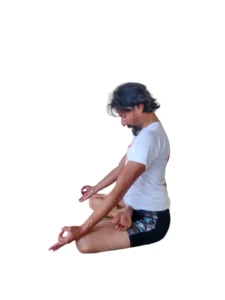 A person performing Padmasana, a lotus pose in yoga, with legs crossed and hands resting on the knees.